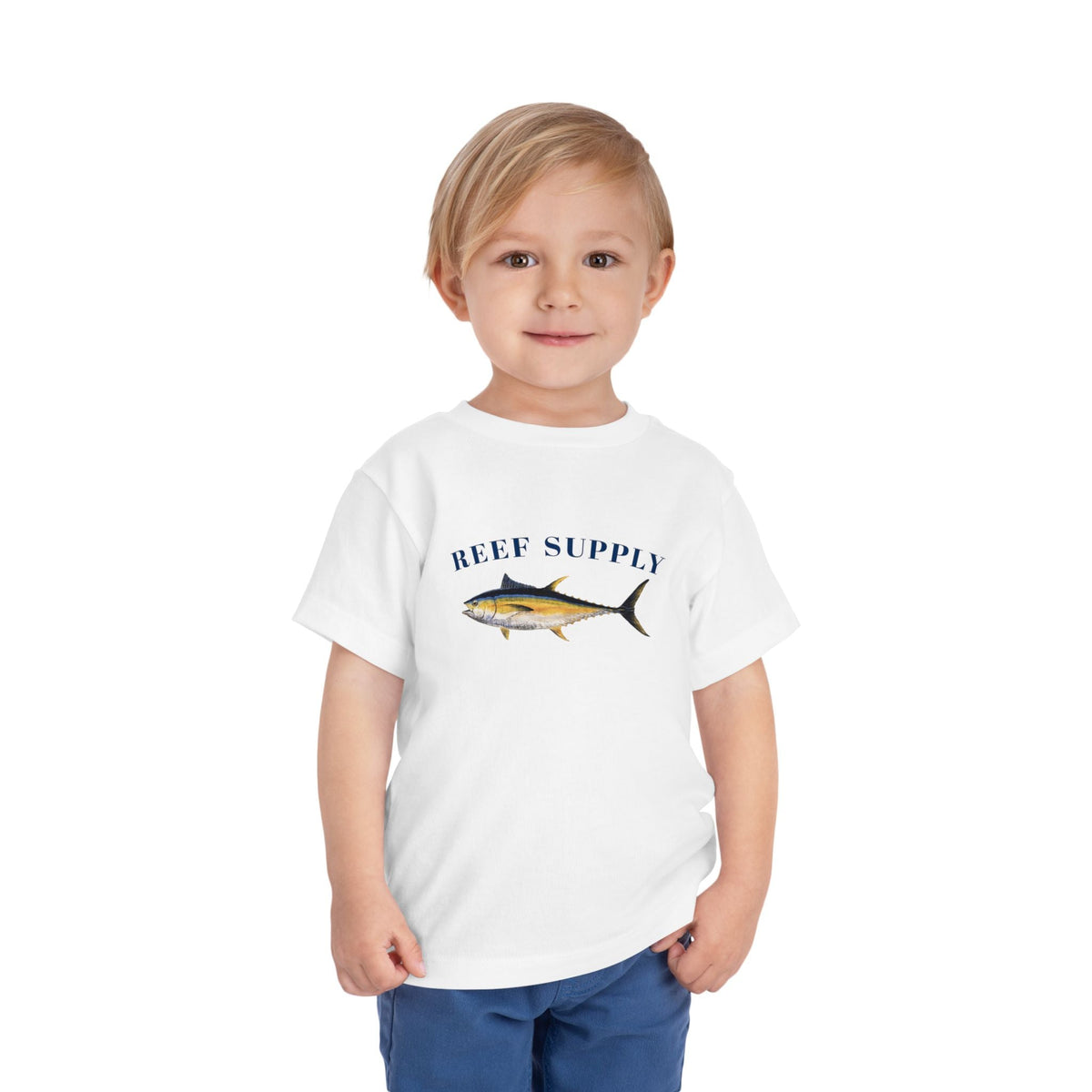 Young boy wearing a white Reef Supply t-shirt with a tuna fish graphic