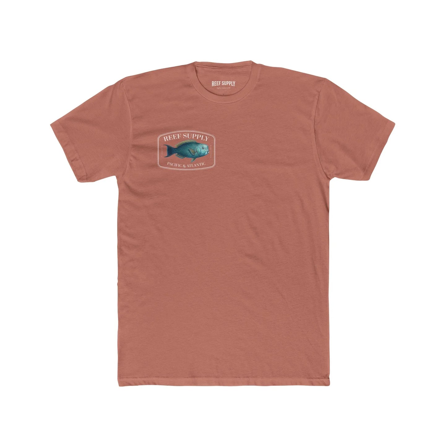 A close-up view of the front of a coral colored premium cotton t-shirt. The centerpiece is a detailed, vibrant illustration of a blue Parrotfish, reflecting its natural colors. The Reef Supply brand logo is arched over the top of the fish, with 'Pacific & Atlantic' text printed in a clean font beneath it, highlighting our coastal inspiration