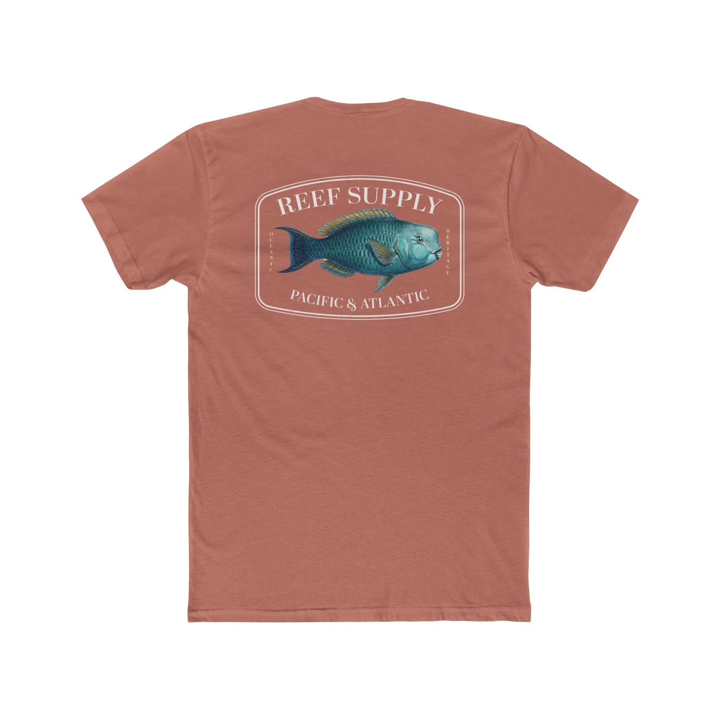 A close-up view of the back of a coral colored premium cotton t-shirt. The centerpiece is a detailed, vibrant illustration of a blue Parrotfish, reflecting its natural colors. The Reef Supply brand logo is arched over the top of the fish, with 'Pacific & Atlantic' text printed in a clean font beneath it, highlighting our coastal inspiration