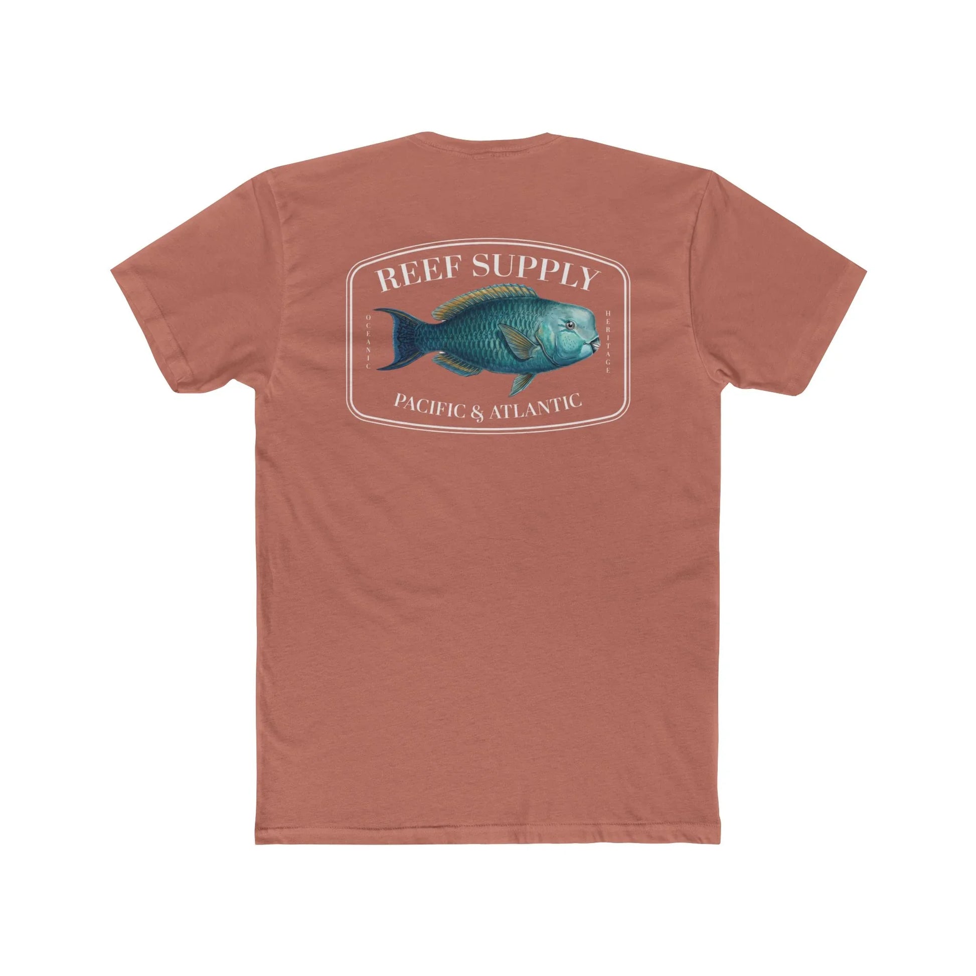 A close-up view of the back of a coral colored premium cotton t-shirt. The centerpiece is a detailed, vibrant illustration of a blue Parrotfish, reflecting its natural colors. The Reef Supply brand logo is arched over the top of the fish, with 'Pacific & Atlantic' text printed in a clean font beneath it, highlighting our coastal inspiration