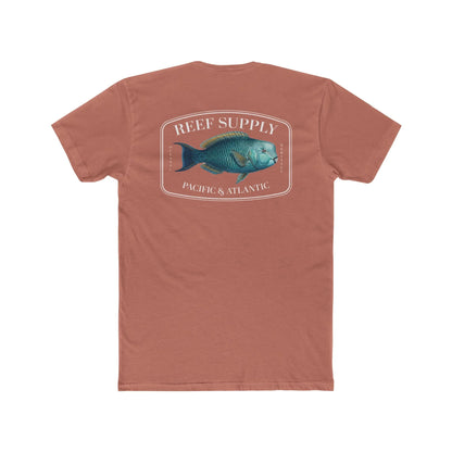 A close-up view of the back of a coral colored premium cotton t-shirt. The centerpiece is a detailed, vibrant illustration of a blue Parrotfish, reflecting its natural colors. The Reef Supply brand logo is arched over the top of the fish, with 'Pacific & Atlantic' text printed in a clean font beneath it, highlighting our coastal inspiration