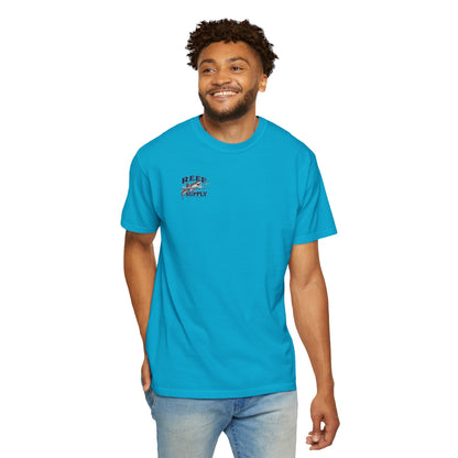 Man wearing a bright blue Reef Supply Tiger Tee with a logo on the chest.