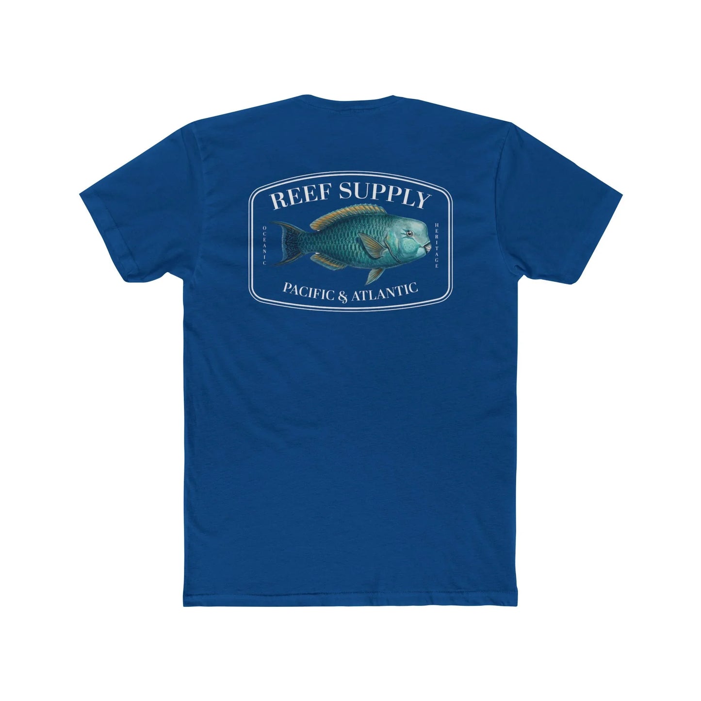A close-up view of the back of a royal blue premium cotton t-shirt. The centerpiece is a detailed, vibrant illustration of a blue Parrotfish, reflecting its natural colors. The Reef Supply brand logo is arched over the top of the fish, with 'Pacific & Atlantic' text printed in a clean font beneath it, highlighting our coastal inspiration