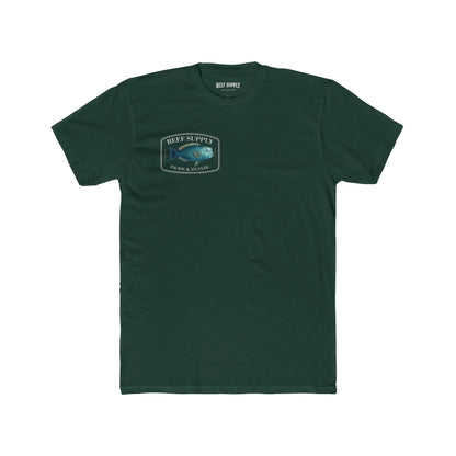 A close-up view of the front of a forest green premium cotton t-shirt. The centerpiece is a detailed, vibrant illustration of a blue Parrotfish, reflecting its natural colors. The Reef Supply brand logo is arched over the top of the fish, with 'Pacific & Atlantic' text printed in a clean font beneath it, highlighting our coastal inspiration