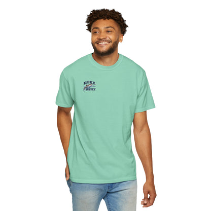 Man wearing a mint green Reef Supply Tiger Tee with a graphic logo on the chest.