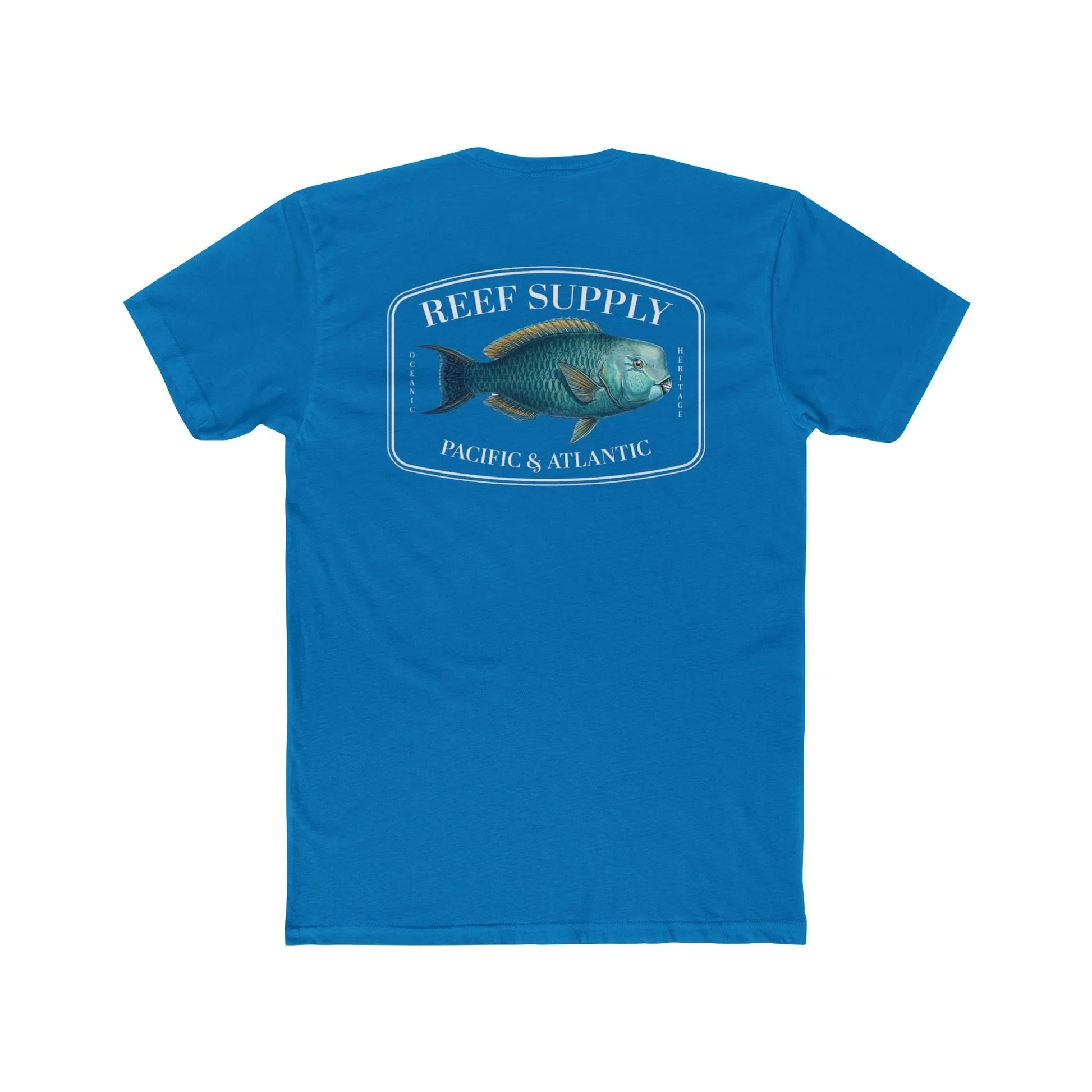 A close-up view of the back of a blue premium cotton t-shirt. The centerpiece is a detailed, vibrant illustration of a blue Parrotfish, reflecting its natural colors. The Reef Supply brand logo is arched over the top of the fish, with 'Pacific & Atlantic' text printed in a clean font beneath it, highlighting our coastal inspiration