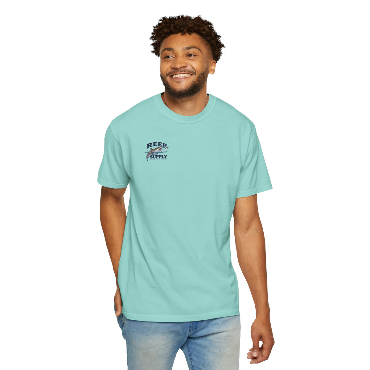 Man wearing a light turquoise Reef Supply Tiger Tee with a shark graphic logo.