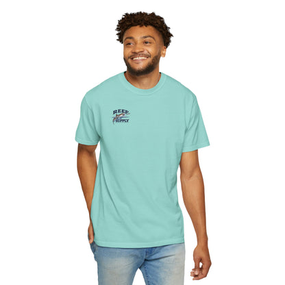 Man wearing a light turquoise Reef Supply Tiger Tee with a shark graphic logo.