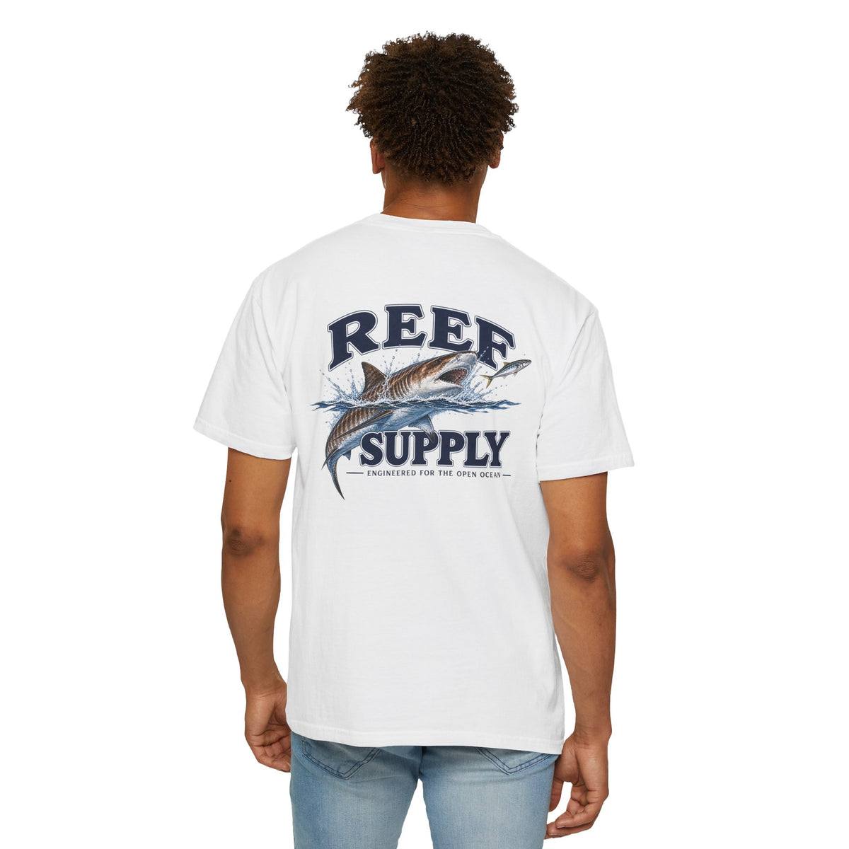 Back view of a person wearing a white Reef Supply Tiger Tee with a shark graphic.
