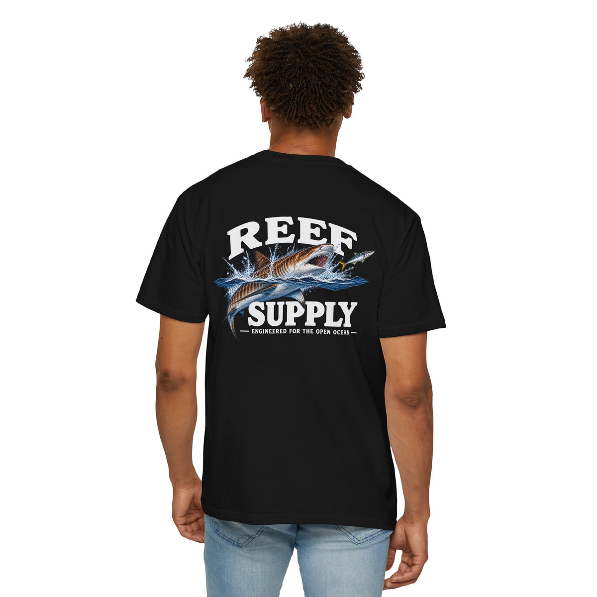 Back view of a man wearing a black Reef Supply Tiger Tee with a shark graphic.