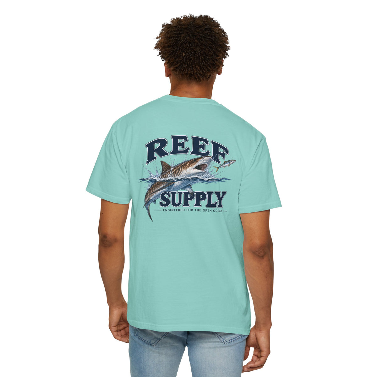 Back view of a light blue Reef Supply Tiger Tee featuring a shark graphic.