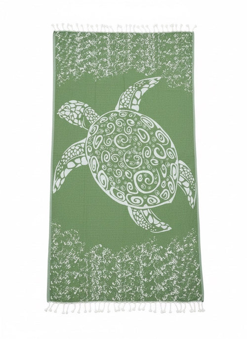 Green towel with a white sea turtle design on a white background